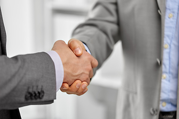 Image showing close up of businessmen making handshake at office