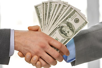 Image showing close up of businessmen's hands holding money