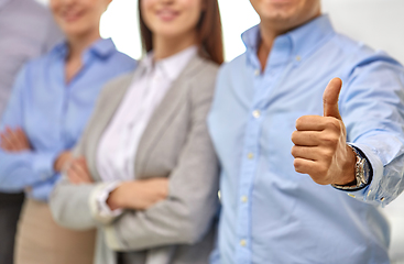 Image showing close up of happy businessman showing thumbs up