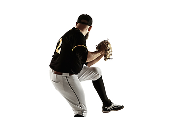 Image showing Baseball player, pitcher in a black uniform practicing on a white background.