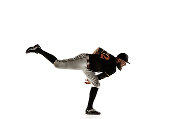 Image showing Baseball player, pitcher in a black uniform practicing on a white background.