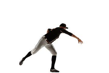 Image showing Baseball player, pitcher in a black uniform practicing on a white background.