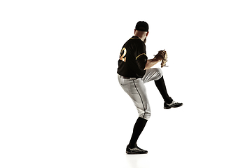 Image showing Baseball player, pitcher in a black uniform practicing on a white background.