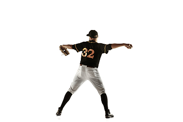 Image showing Baseball player, pitcher in a black uniform practicing on a white background.