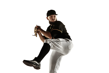 Image showing Baseball player, pitcher in a black uniform practicing on a white background.