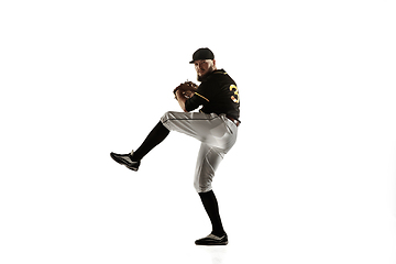 Image showing Baseball player, pitcher in a black uniform practicing on a white background.