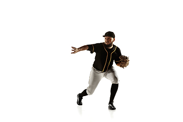 Image showing Baseball player, pitcher in a black uniform practicing on a white background.