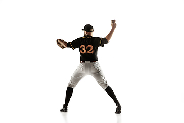 Image showing Baseball player, pitcher in a black uniform practicing on a white background.