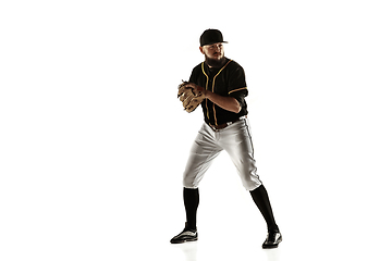 Image showing Baseball player, pitcher in a black uniform practicing on a white background.