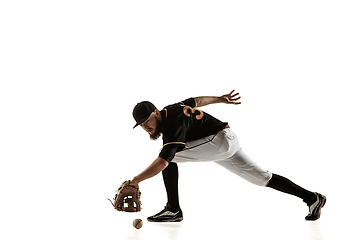 Image showing Baseball player, pitcher in a black uniform practicing on a white background.