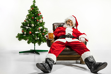 Image showing Santa Claus drinking beer near Christmas tree, congratulating of New Year 2020