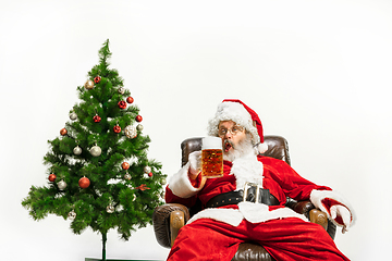 Image showing Santa Claus drinking beer near Christmas tree, congratulating of New Year 2020