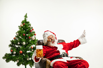 Image showing Santa Claus drinking beer near Christmas tree, congratulating of