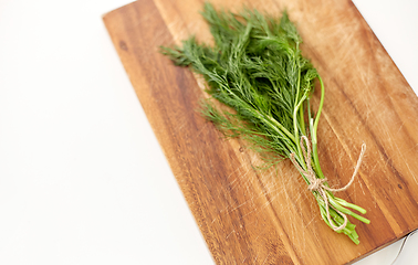 Image showing bunch of dill on wooden cutting board