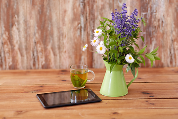 Image showing tablet computer, herbal tea and flowers in jug