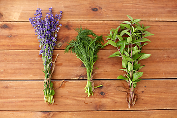 Image showing lavender, dill and peppermint on wooden background
