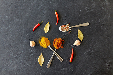Image showing spices, chili pepper, bay leaf and garlic on stone