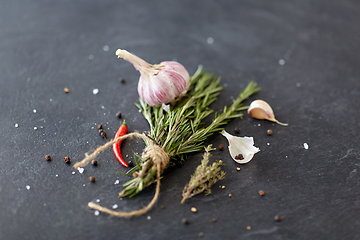 Image showing rosemary, garlic and chili pepper on stone surface