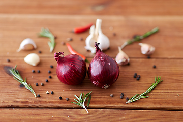 Image showing onion, garlic, chili pepper and rosemary on table