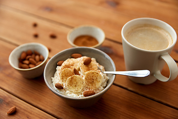 Image showing oatmeal with banana and almond on wooden table