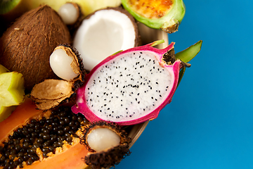 Image showing plate of exotic fruits on blue background