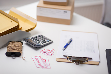 Image showing calculator, clipboard and envelopes at post office