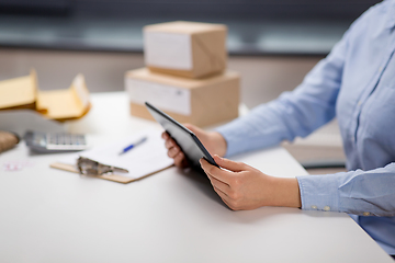 Image showing close up of woman with tablet pc at post office