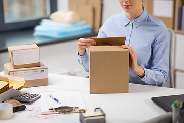 Image showing woman packing parcel box at post office