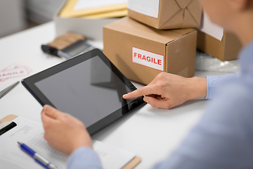 Image showing hands with tablet pc and clipboard at post office