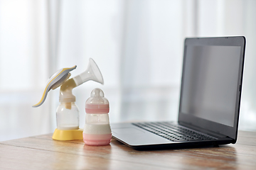 Image showing baby milk formula, breast pump and laptop