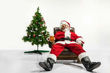 Image showing Santa Claus drinking beer near Christmas tree, congratulating of New Year 2020