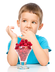 Image showing Little boy with raspberries
