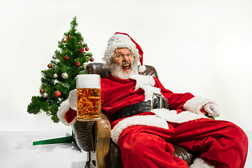 Image showing Santa Claus drinking beer near Christmas tree, congratulating of