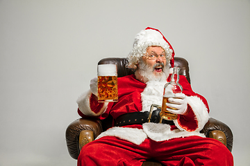 Image showing Santa Claus drinking beer sitting on armchair, congratulating of New Year 2020