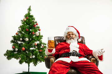 Image showing Santa Claus drinking beer near Christmas tree, congratulating of New Year 2020