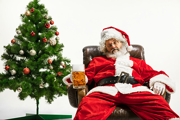 Image showing Santa Claus drinking beer near Christmas tree, congratulating of New Year 2020