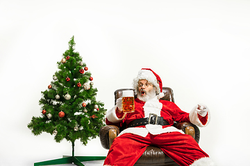 Image showing Santa Claus drinking beer near Christmas tree, congratulating of New Year 2020