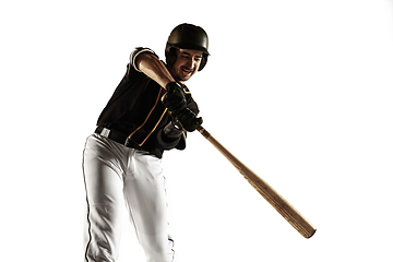 Image showing Baseball player, pitcher in a black uniform practicing on a white background.