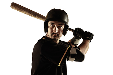 Image showing Baseball player, pitcher in a black uniform practicing on a white background.