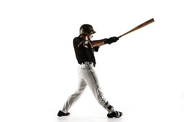 Image showing Baseball player, pitcher in a black uniform practicing on a white background.