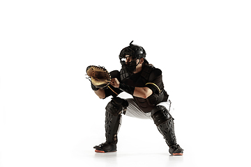 Image showing Baseball player, pitcher in a black uniform practicing on a white background.