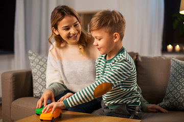 Image showing mother and son playing with toy cars at home