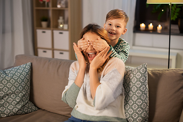 Image showing happy smiling mother playing with her son at home