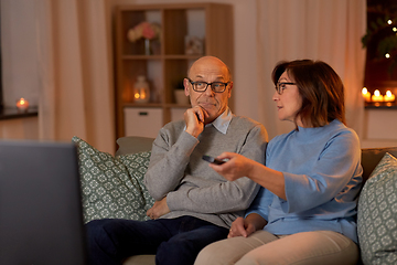 Image showing senior couple watching tv at home in evening