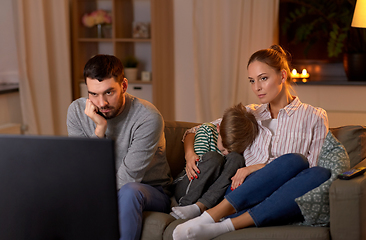 Image showing family watching something boring on tv at night