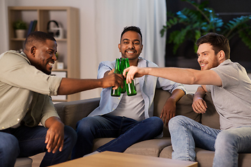 Image showing happy male friends drinking beer at home at night