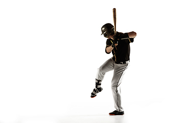 Image showing Baseball player, pitcher in a black uniform practicing on a white background.