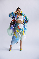 Image showing Woman addicted of sales and clothes, wearing plastic, recycling concept