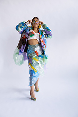 Image showing Woman addicted of sales and clothes, wearing plastic, recycling concept