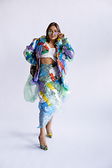 Image showing Woman addicted of sales and clothes, wearing plastic, recycling concept